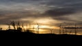 Windmills for electric power production with sunset sunlight