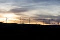 Windmills for electric power production with sunset sunlight