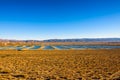 Windmills farm and water reservoirs along a highway in Mojave desert Royalty Free Stock Photo