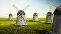 Windmills on the green field. 3D illustration