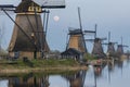 Windmills of Kinderdijk Alblasserdam UNESCO site under a rising full moon Royalty Free Stock Photo