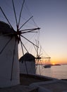 Windmills at Mykonos at sunset at sea and the ship Royalty Free Stock Photo