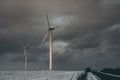 windmills near the asphalt road in winter Royalty Free Stock Photo