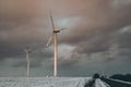 windmills near the asphalt road in winter Royalty Free Stock Photo