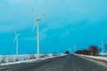windmills near the asphalt road in winter Royalty Free Stock Photo