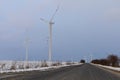 windmills near the asphalt road in winter Royalty Free Stock Photo