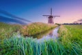 Windmills in the Netherlands. Historic buildings. Agriculture. Summer landscape during sunset. Bright sky and windmill. Royalty Free Stock Photo