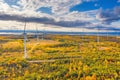 The Windmills park of Paldiski. Wind turbine farm near Baltic sea. Autumn landscape with windmills, orange forest and Royalty Free Stock Photo