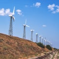 Windmills for power generation on a bright summer day Royalty Free Stock Photo