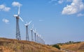 Windmills for power generation on a bright summer day Royalty Free Stock Photo