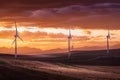 Windmills at sunset generating electricity overlooking distant mountains near Pincher Creek Alberta Canada Royalty Free Stock Photo