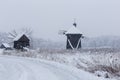 Windmills in Village Museum during snowy winter Royalty Free Stock Photo