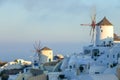 Windmills and White Houses on a Mountainside in Santorini Royalty Free Stock Photo