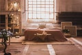 Window above bed with cushions in japanese bedroom interior with bonsai and lights