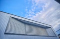 Window of metal sheet building with vivid blue sky Royalty Free Stock Photo