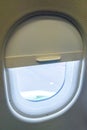 The window of the airplane. A view of porthole window on board an airbus for your travel concept or passenger air transportation Royalty Free Stock Photo