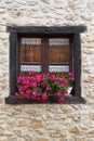 Window of an ancient house decorated with flowers Royalty Free Stock Photo
