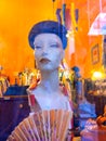 Window of an antique shop with a mannequin in a beret and a fan in Kazimierz, the Jewish district of Krakow.