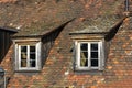 Window of attic on medieval tiled roof