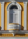 Snow-white window against a bright yellow building