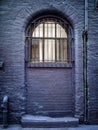 Window with bars in a blue painted brick wall Royalty Free Stock Photo