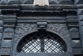 Window with bars in the old building of classical architecture