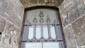 A window with bars on the Old castle from the outside