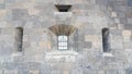 A window with bars on the Old castle from the outside