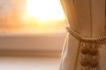 Window with beautiful beige curtain, closeup Royalty Free Stock Photo