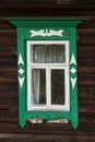 Window with beautiful fretted wooden case . It`s a traditional decoration of old russian wooden houses. Royalty Free Stock Photo