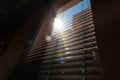Window blinds blurry photo. Defocused jalousies with direct sunlight