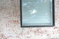 Window with blinds in an old brick wall Royalty Free Stock Photo