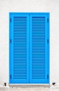 A window with blue shutters on a white wall Royalty Free Stock Photo