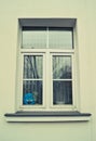 A window with a blue smiling smiley behind the glass