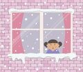 Window on a brick wall on a snowy day. A little girl in the room is surprised, looking at the snow