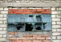 Window with broken glass blocks. Glass blocks in a window on a brick wall. Royalty Free Stock Photo