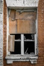The window with broken glass of a destroyed building. Antique exterior, abandoned architecture. Ruin, damage. Broken window of old