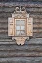 Window with carved architraves in a wooden hut. Royalty Free Stock Photo