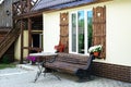 Window with carved doors and with flower pots on the facade of t Royalty Free Stock Photo