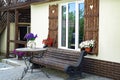 Window with carved doors and with flower pots on the facade of t Royalty Free Stock Photo