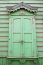 Window with carving architraves and closed shutters Royalty Free Stock Photo