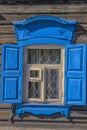 Window with carving architraves and closed shutters. Royalty Free Stock Photo