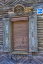 Window with carving architraves and closed shutters. Royalty Free Stock Photo