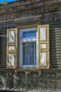 Window with carving architraves and closed shutters. Royalty Free Stock Photo