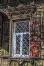 Window with carving architraves and closed shutters. Royalty Free Stock Photo