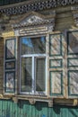 Window with carving architraves and closed shutters. Royalty Free Stock Photo