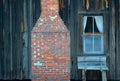 Window and Chimney in an Old Clapboard Farmhouse Royalty Free Stock Photo