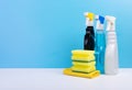 Window Cleaner In A Colorful Plastic Spray Bottles And Sponges On Blue Background. Cleaning Concept