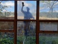 Window cleaner silhouette in action on a dirty facade.