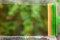 Window cleaner using a squeegee to wash a window. Clean horizontal bar Royalty Free Stock Photo